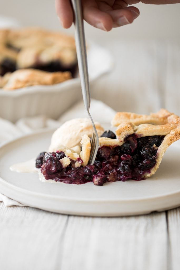 Summery classic blueberry pie is made with the perfect flaky pie crust, a jammy blueberry filling with a hint of lemon, and sealed with a lattice top. | aheadofthyme.com