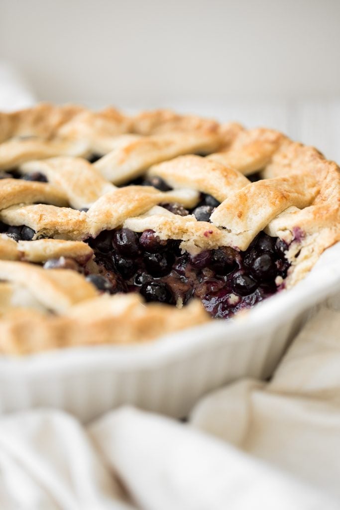 Summery classic blueberry pie is made with the perfect flaky pie crust, a jammy blueberry filling with a hint of lemon, and sealed with a lattice top. | aheadofthyme.com