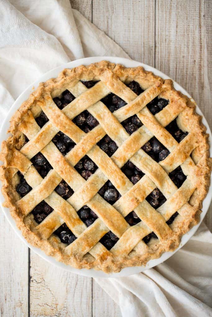 Summery classic blueberry pie is made with the perfect flaky pie crust, a jammy blueberry filling with a hint of lemon, and sealed with a lattice top. | aheadofthyme.com