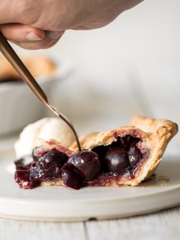 Summery and fruity, classic cherry pie has the most flakey and buttery pie crust on the bottom and top and is filled with a delicious cherry-packed filling. | aheadofthyme.com