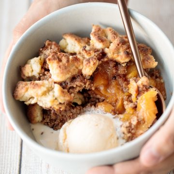 Easy peach cobbler is packed with sweet and juicy fresh peaches and topped with a buttery, golden topping. Make it with just 15-minutes of actual prep work. | aheadofthyme.com