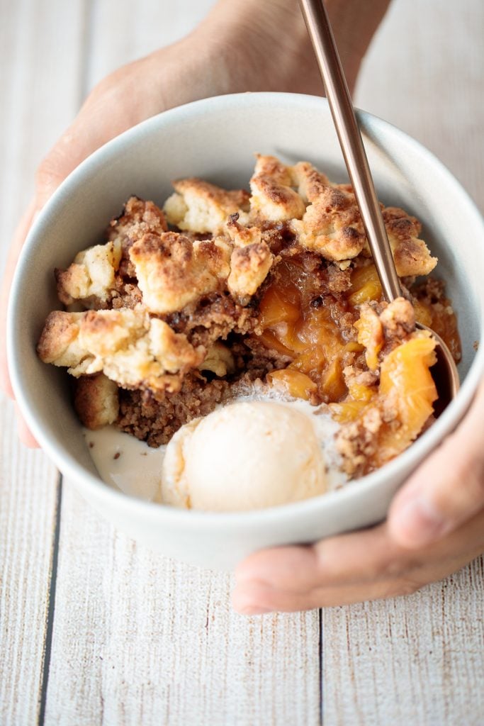 Easy peach cobbler is packed with sweet and juicy fresh peaches and topped with a buttery, golden topping. Make it with just 15-minutes of actual prep work. | aheadofthyme.com