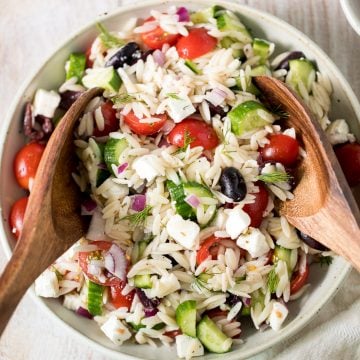 Quick and easy Mediterranean orzo pasta salad packed with fresh vegetables and herbs is tossed in a Greek lemon vinaigrette. Healthy, light and delicious. | aheadofthyme.com