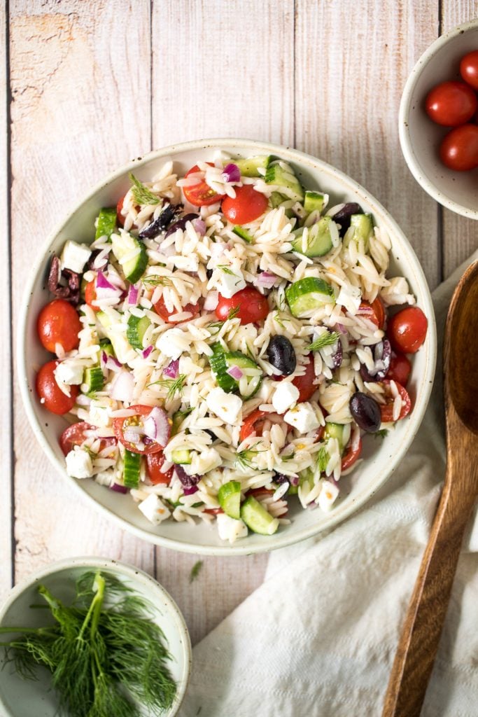 Quick and easy Mediterranean orzo pasta salad packed with fresh vegetables and herbs is tossed in a Greek lemon vinaigrette. Healthy, light and delicious. | aheadofthyme.com