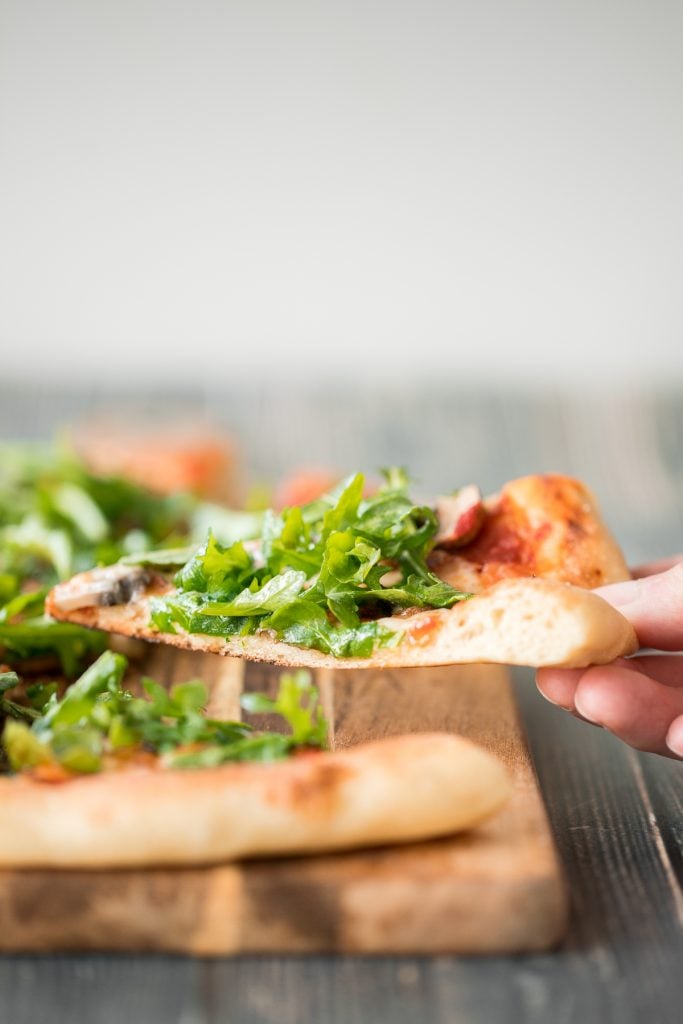 Easy and delicious homemade mushroom and arugula skillet pizza with a perfectly crispy pizza crust is topped with mushrooms, arugula, and mozzarella cheese. | aheadofthyme.com