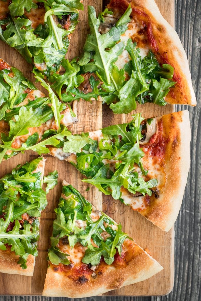 Easy and delicious homemade mushroom and arugula skillet pizza with a perfectly crispy pizza crust is topped with mushrooms, arugula, and mozzarella cheese. | aheadofthyme.com