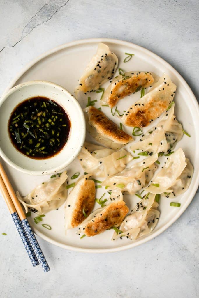 Wrinkly crispy pork and sardine dumplings (potstickers) with vinegar dipping sauce, are filled with pork, canned sardines, green onions and Asian seasoning. | aheadofthyme.com