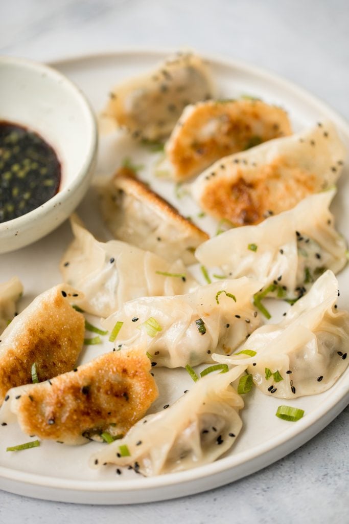 Wrinkly crispy pork and sardine dumplings (potstickers) with vinegar dipping sauce, are filled with pork, canned sardines, green onions and Asian seasoning. | aheadofthyme.com