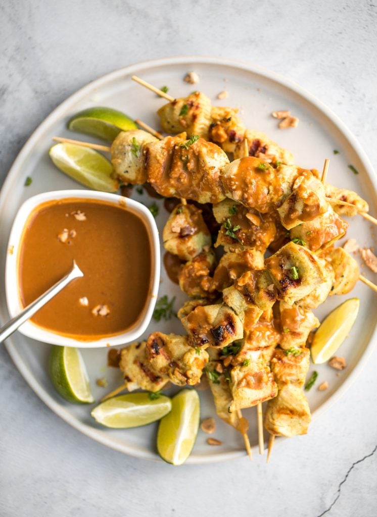 Better than takeout, easy to make tender chicken satay skewers with coconut marinade and homemade peanut dipping sauce is savoury, sweet, tangy, and nutty. | aheadofthyme.com