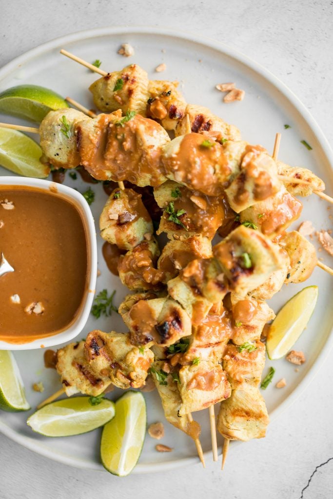 Better than takeout, easy to make tender chicken satay skewers with coconut marinade and homemade peanut dipping sauce is savoury, sweet, tangy, and nutty. | aheadofthyme.com