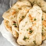 Freshly baked small batch garlic naan bread is buttery, garlicky, soft and pillowy, and full of perfect blistered air pockets. It's quick and easy to make. | aheadofthyme.com