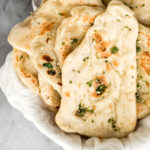 Freshly baked small batch garlic naan bread is buttery, garlicky, soft and pillowy, and full of perfect blistered air pockets. It's quick and easy to make. | aheadofthyme.com