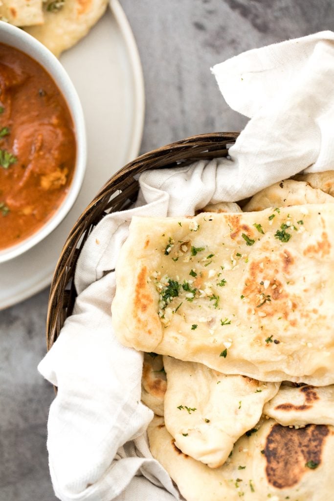 Freshly baked small batch garlic naan bread is buttery, garlicky, soft and pillowy, and full of perfect blistered air pockets. It's quick and easy to make. | aheadofthyme.com