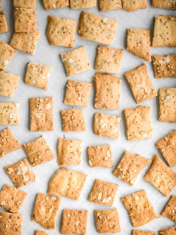 Quick and easy sourdough discard crackers are thin, crispy, crunchy and flavoured with sesame seeds, dried herbs and flaked salt. They are so addictive. | aheadofthyme.com