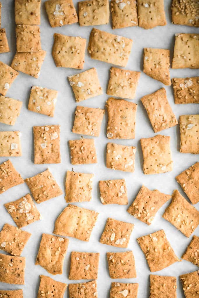 Quick and easy sourdough discard crackers are thin, crispy, crunchy and flavoured with sesame seeds, dried herbs and flaked salt. They are so addictive. | aheadofthyme.com