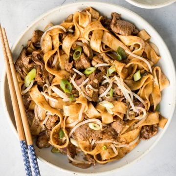 Better than takeout, flavourful stir-fried spicy cumin lamb noodles is packed with marinated lamb, noodles, and crisp bean sprouts. Make it in 15 minutes. | aheadofthyme.com