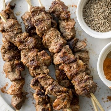 Juicy and tender, Xinjiang spicy cumin lamb skewers with a bold cumin and cayenne marinade, are so flavourful and easy to make on the grill or air fryer. | aheadofthyme.com