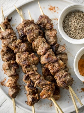 Juicy and tender, Xinjiang spicy cumin lamb skewers with a bold cumin and cayenne marinade, are so flavourful and easy to make on the grill or air fryer. | aheadofthyme.com