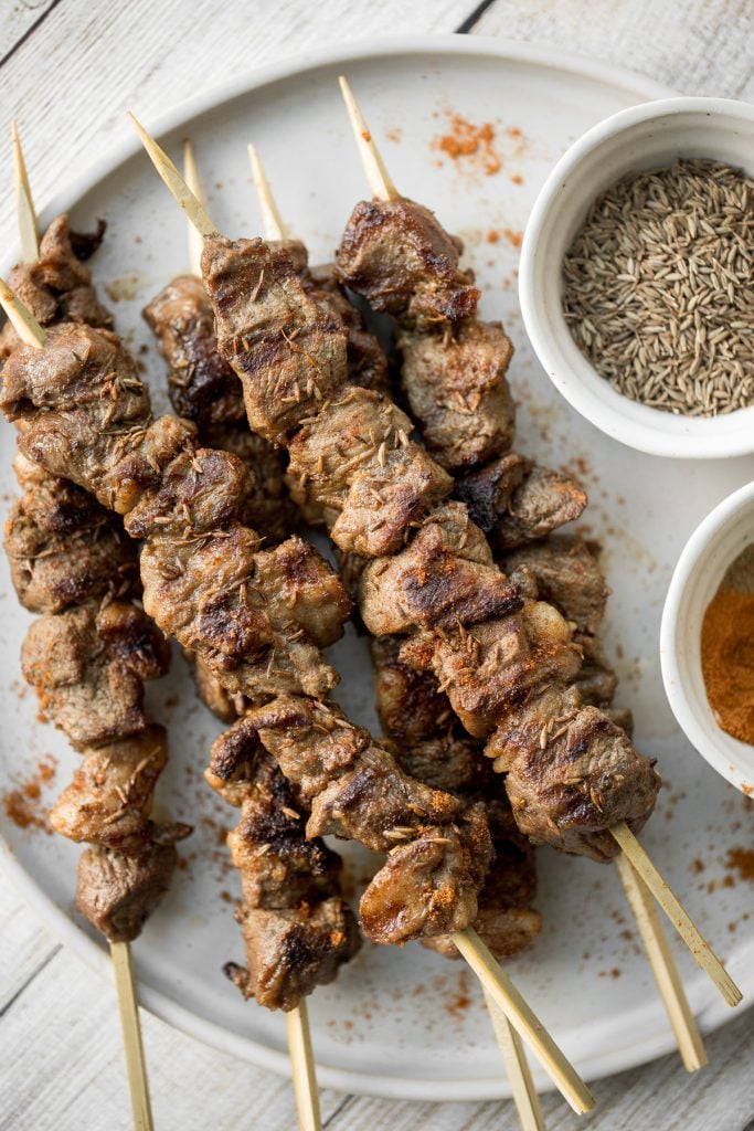 Juicy and tender, Xinjiang spicy cumin lamb skewers with a bold cumin and cayenne marinade, are so flavourful and easy to make on the grill or air fryer. | aheadofthyme.com