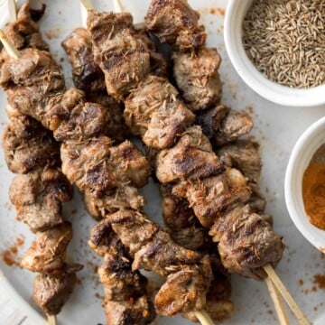 Juicy and tender, Xinjiang Spicy Cumin Lamb Skewers with a bold cumin and cayenne marinade, are so flavourful and easy to make on the grill or air fryer. | aheadofthyme.com