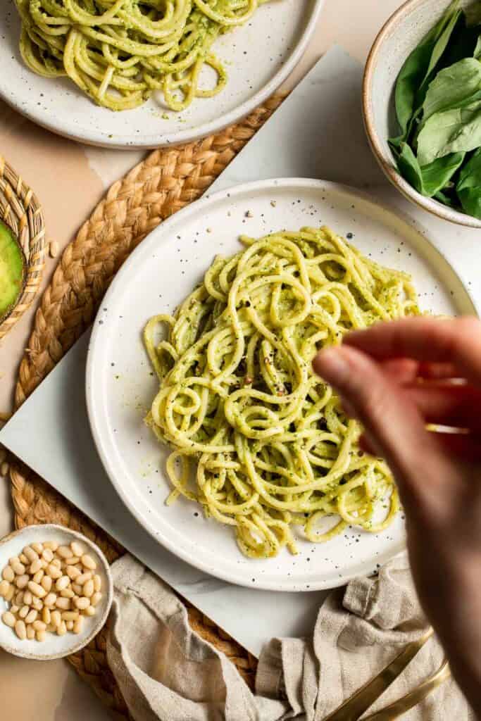 This creamy Avocado Pesto Pasta is healthy, light, and delicious. This quick and easy vegan pasta comes together in just 15 minutes (including prep!). | aheadofthyme.com