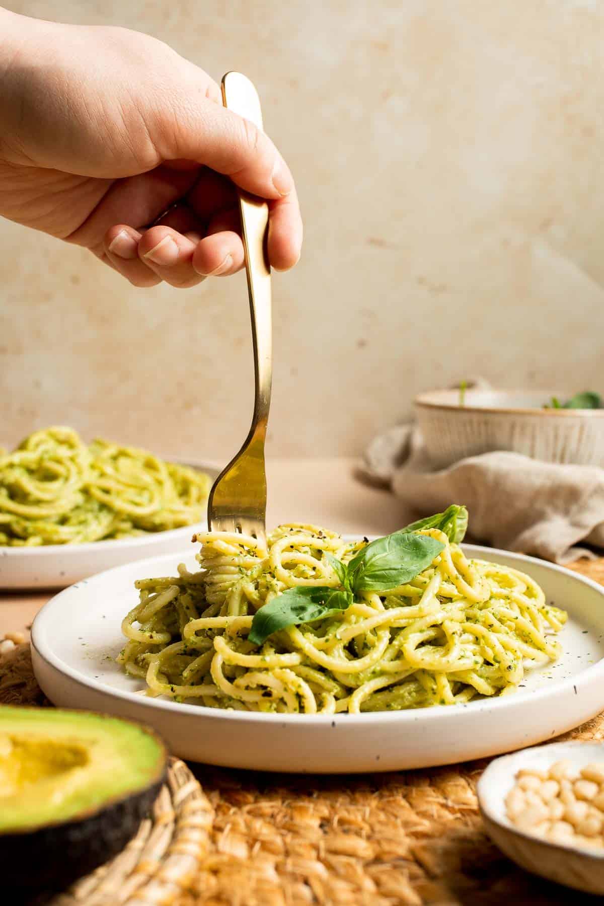 This creamy Avocado Pesto Pasta is healthy, light, and delicious. This quick and easy vegan pasta comes together in just 15 minutes (including prep!). | aheadofthyme.com