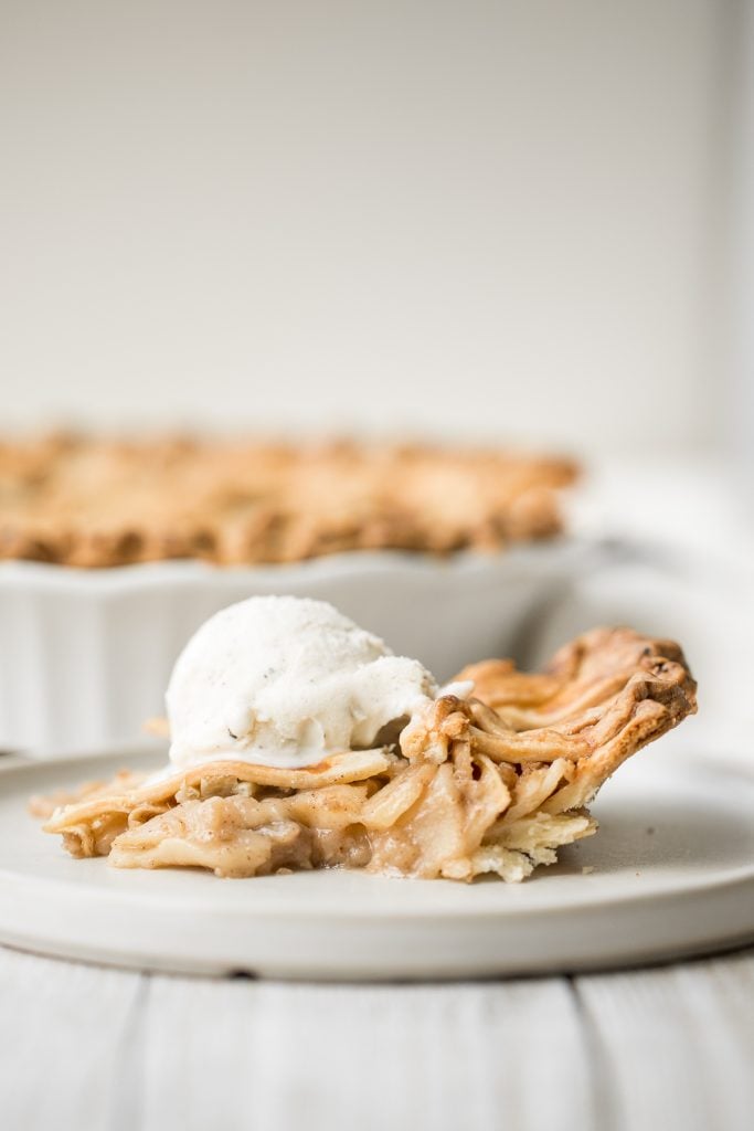 This braided lattice apple pie is packed with cinnamon apples tossed in a caramel sauce and sealed in a buttery, flaky pie crust with a braided lattice top. | aheadofthyme.com