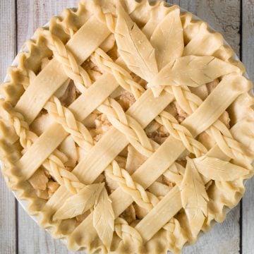 This braided lattice apple pie is packed with cinnamon apples tossed in a caramel sauce and sealed in a buttery, flaky pie crust with a braided lattice top. | aheadofthyme.com