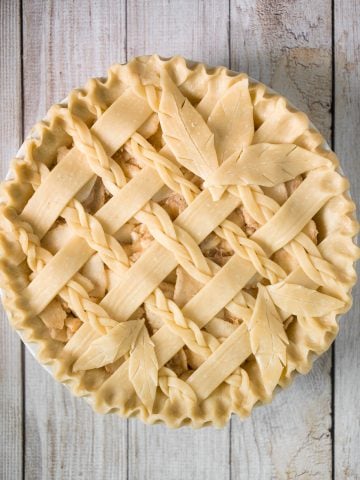 This braided lattice apple pie is packed with cinnamon apples tossed in a caramel sauce and sealed in a buttery, flaky pie crust with a braided lattice top. | aheadofthyme.com