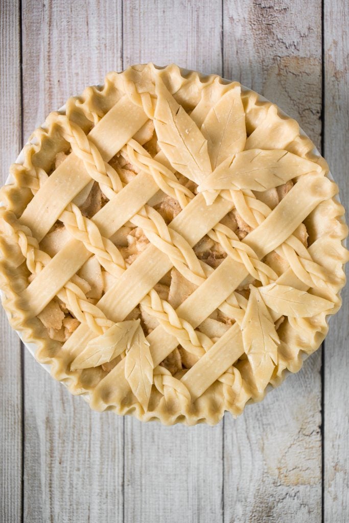 This braided lattice apple pie is packed with cinnamon apples tossed in a caramel sauce and sealed in a buttery, flaky pie crust with a braided lattice top. | aheadofthyme.com