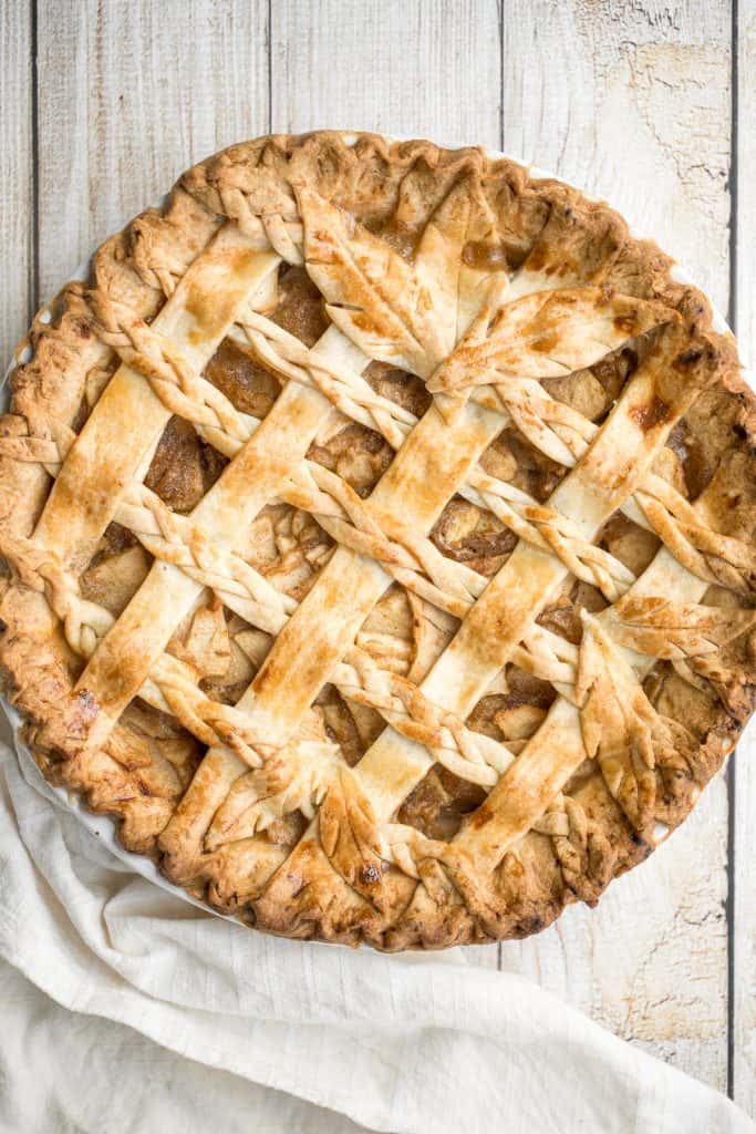 This braided lattice apple pie is packed with cinnamon apples tossed in a caramel sauce and sealed in a buttery, flaky pie crust with a braided lattice top. | aheadofthyme.com