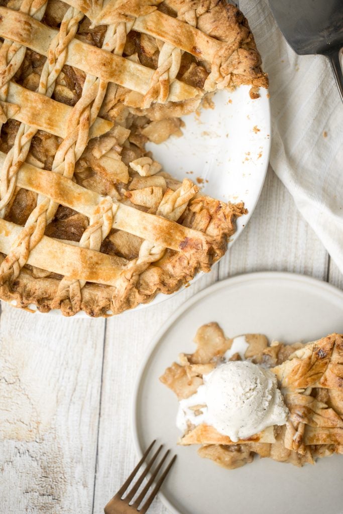 This braided lattice apple pie is packed with cinnamon apples tossed in a caramel sauce and sealed in a buttery, flaky pie crust with a braided lattice top. | aheadofthyme.com