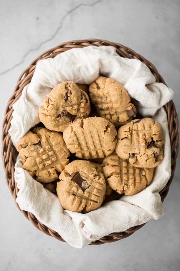 These perfectly soft, chewy and a little crumby chocolate chunk peanut butter cookies literally melts in your mouth. Make them in under 20 minutes. | aheadofthyme.com