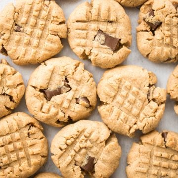 These perfectly soft, chewy and a little crumby chocolate chunk peanut butter cookies literally melts in your mouth. Make them in under 20 minutes. | aheadofthyme.com