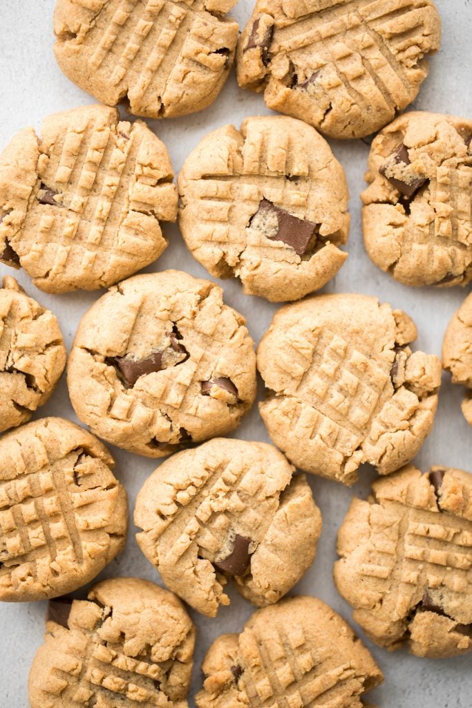 These perfectly soft, chewy and a little crumby chocolate chunk peanut butter cookies literally melts in your mouth. Make them in under 20 minutes. | aheadofthyme.com