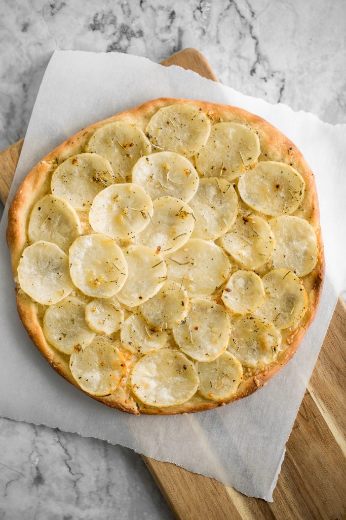 Easy and simple yet flavourful classic Roman herbed potato pizza has a crispy thin crust with layers of tender potato tossed in olive oil and herbs. | aheadofthyme.com