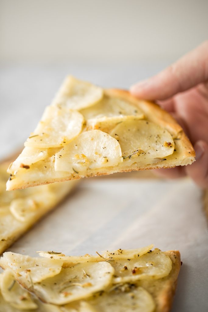 Easy and simple yet flavourful classic Roman herbed potato pizza has a crispy thin crust with layers of tender potato tossed in olive oil and herbs. | aheadofthyme.com