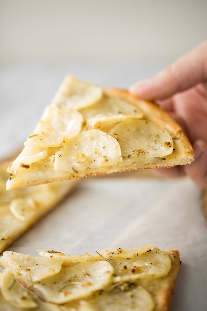 Easy and simple yet flavourful classic Roman herbed potato pizza has a crispy thin crust with layers of tender potato tossed in olive oil and herbs. | aheadofthyme.com