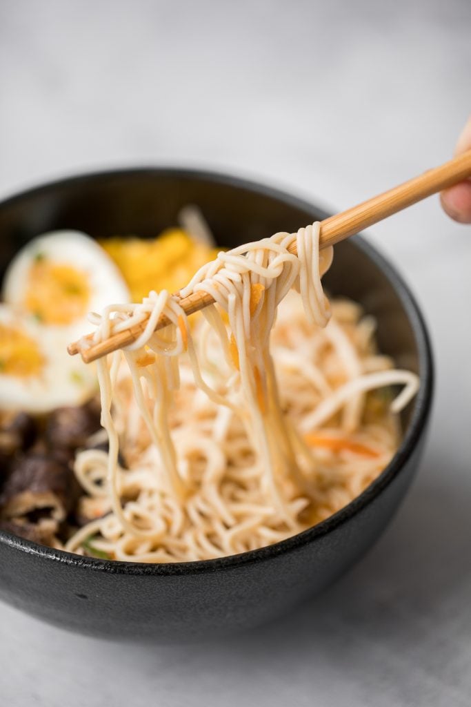 Vegetarian peanut miso ramen with a creamy vegan soup base, is topped with noodles, vegetables, and a perfect soft-boiled egg. Make it in just 20 minutes. | aheadofthyme.com