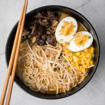 Vegetarian peanut miso ramen with a creamy vegan soup base, is topped with noodles, vegetables, and a perfect soft-boiled egg. Make it in just 20 minutes. | aheadofthyme.com
