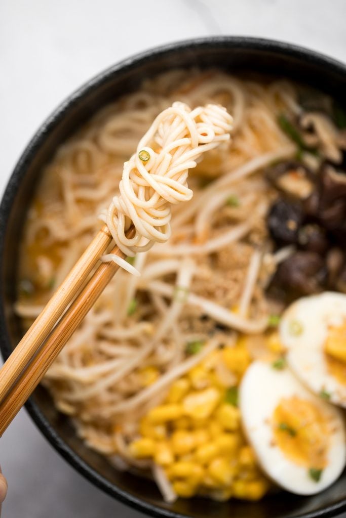 Vegetarian peanut miso ramen with a creamy vegan soup base, is topped with noodles, vegetables, and a perfect soft-boiled egg. Make it in just 20 minutes. | aheadofthyme.com