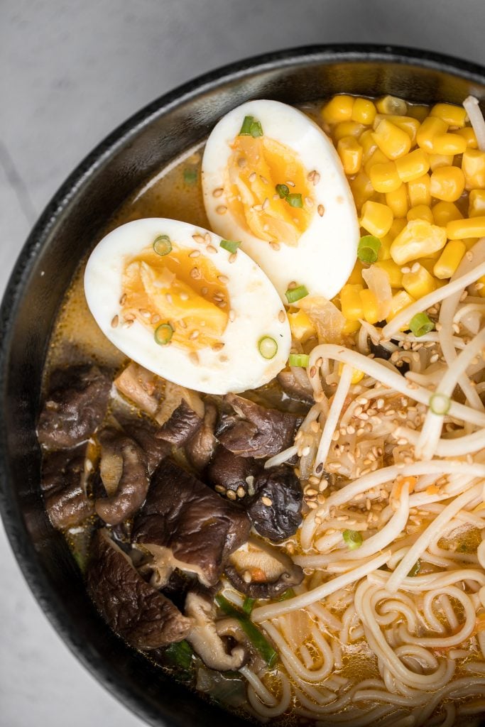 Vegetarian peanut miso ramen with a creamy vegan soup base, is topped with noodles, vegetables, and a perfect soft-boiled egg. Make it in just 20 minutes. | aheadofthyme.com