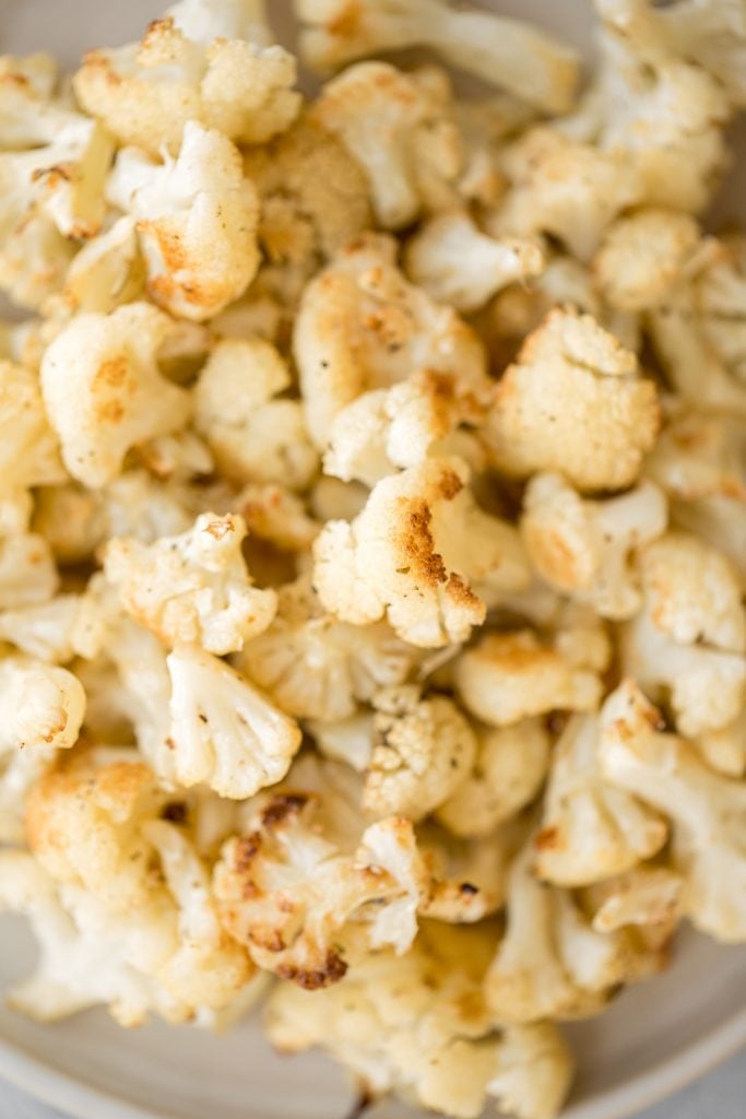 Quick and easy roasted cauliflower is a delicious, flavourful side dish that you throw on a sheet pan and into the oven. Plus, it's vegan and gluten-free. | aheadofthyme.com