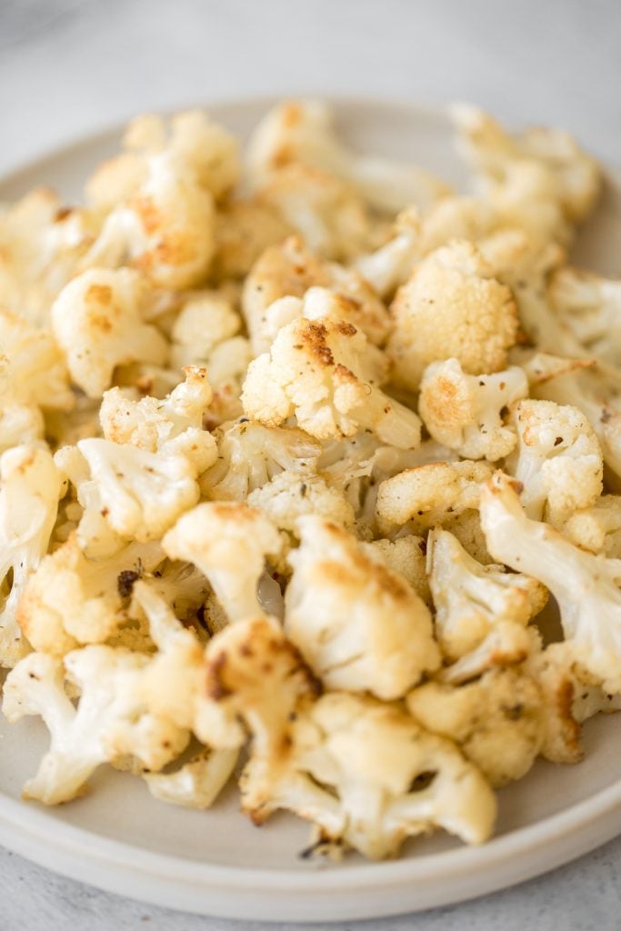 Quick and easy roasted cauliflower is a delicious, flavourful side dish that you throw on a sheet pan and into the oven. Plus, it's vegan and gluten-free. | aheadofthyme.com