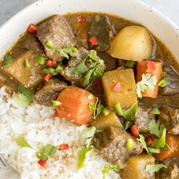 Warm and cozy, easy one pot coconut curry beef stew is hearty yet creamy, packed with tender beef chunks, potatoes and carrots, and creamy coconut milk. | aheadofthyme.com