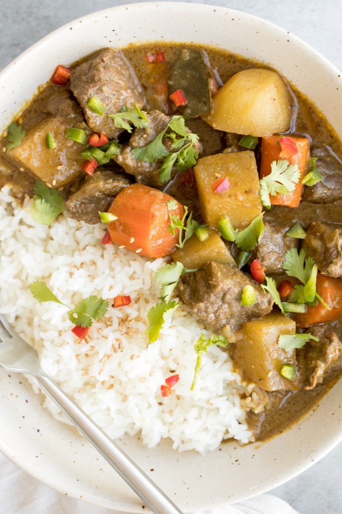 Warm and cozy, easy one pot coconut curry beef stew is hearty yet creamy, packed with tender beef chunks, potatoes and carrots, and creamy coconut milk. | aheadofthyme.com