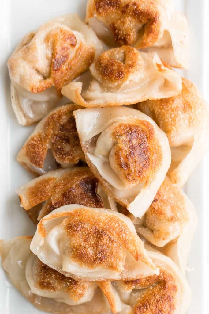 Better than takeout pan-fried pork and shrimp wontons are so crispy outside and tender and juicy inside with a savoury pork, shrimp and vegetable filling. | aheadofthyme.com