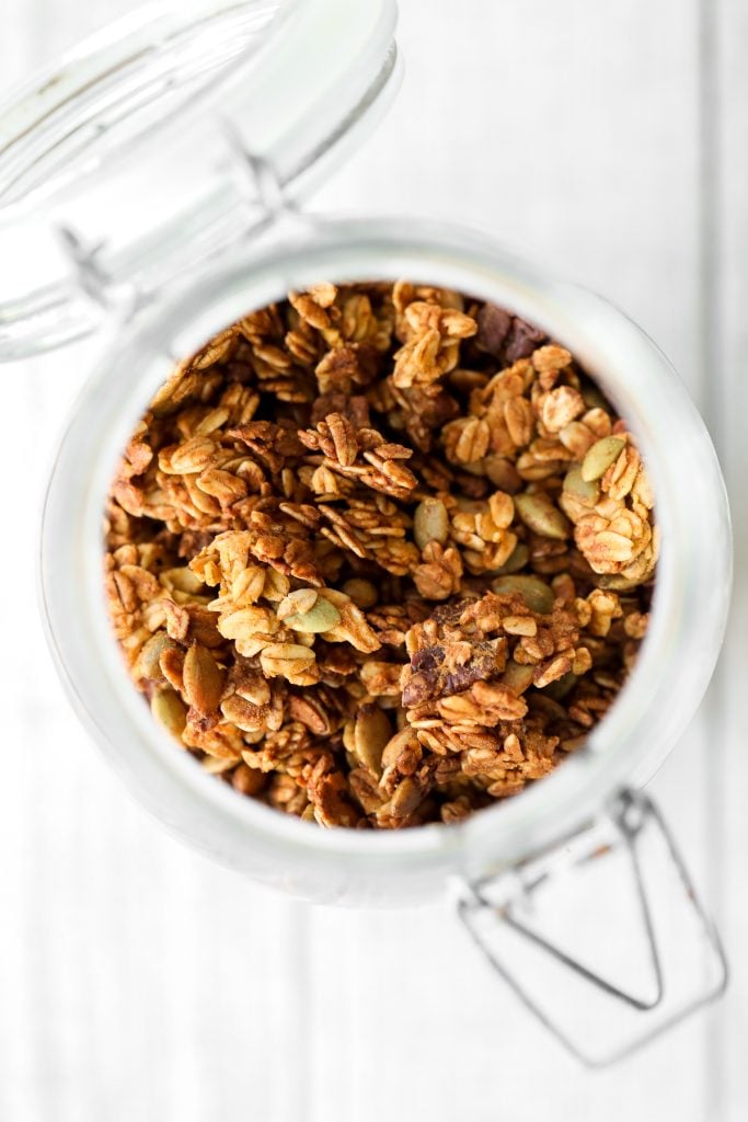 Quick and easy pumpkin pie granola packed with oats, pumpkin, pumpkin spice, and nuts, is vegan, gluten-free, and refined sugar-free. The best fall snack. | aheadofthyme.com