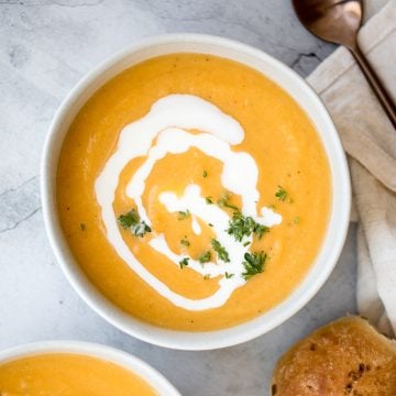 Creamy roasted butternut squash and cauliflower soup has all the fall feels and is vegan and gluten-free. Plus, it's super easy to make in a sheet pan. | aheadofthyme.com