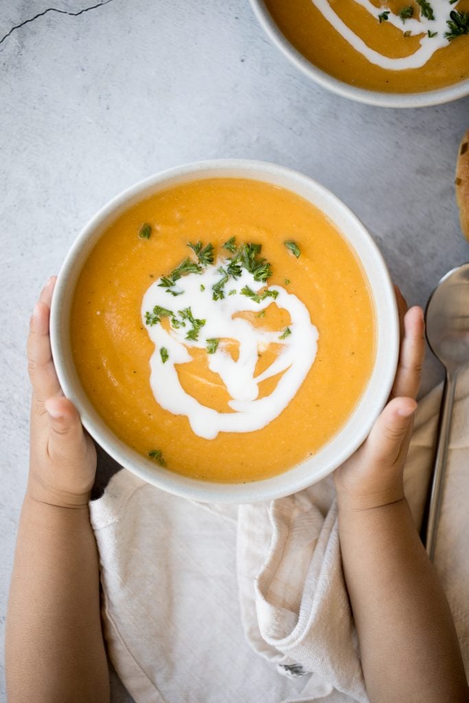 Creamy roasted butternut squash and cauliflower soup has all the fall feels and is vegan and gluten-free. Plus, it's super easy to make in a sheet pan. | aheadofthyme.com